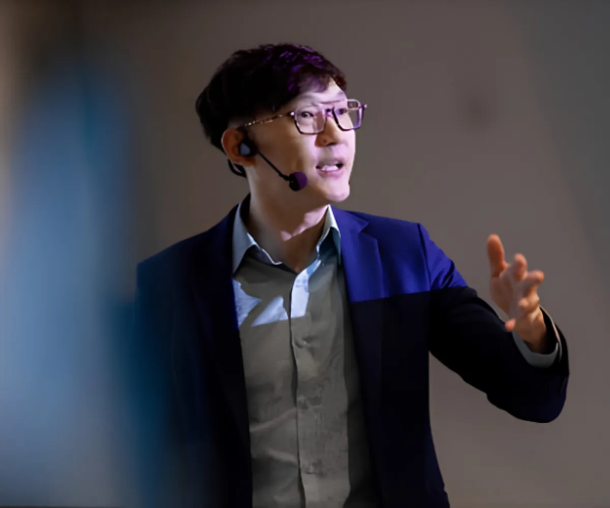 Alexander Ang delivering a keynote on AI and marketing strategies
